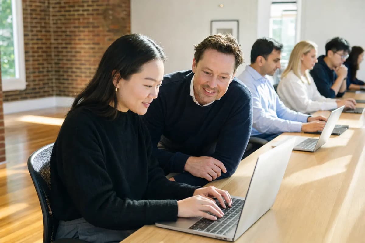 A trainer working through something on screen alongside a colleague